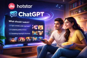 Illustration of a couple watching television at home as the Jio Hotstar app displays a ChatGPT-powered recommendation interface, showing personalized prompts like “What should I watch?” along with suggested movies and shows on screen